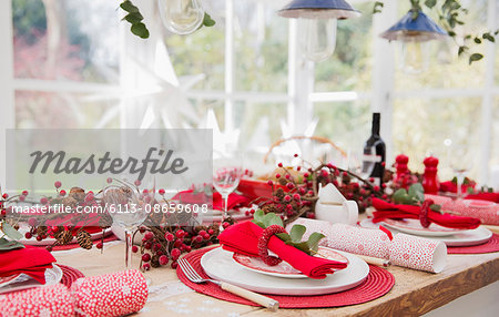 Placesettings and Christmas decorations on dining table