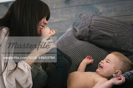 A woman playing with her young son.