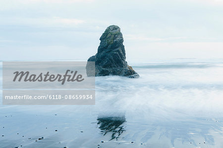 Rock formation on the coastline, exposed on the beach at low tide.