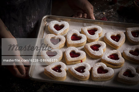 Valentine's Day baking, high angle view of a baking tray with heart shaped biscuits.