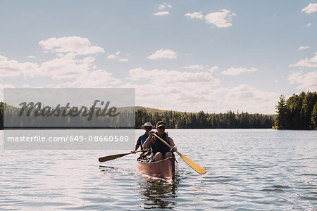 Senior couple canoeing on lake