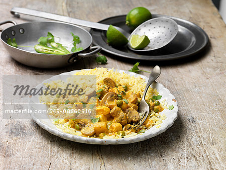 Food, vegetarian meals, paneer and cauliflower korma with pilau rice, green chilli, fresh lime, coriander, vintage bowl, wooden table