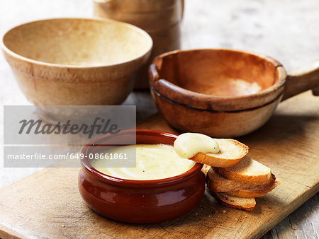 Cheese fondue in terracotta bowl