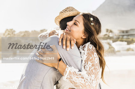 Romantic couple hugging each other on beach, Cape Town, South Africa