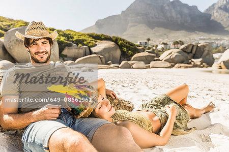 Mid adult couple sunbathing on beach, Cape Town, South Africa