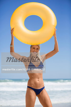 Pretty woman holing an inflatable ring and smiling