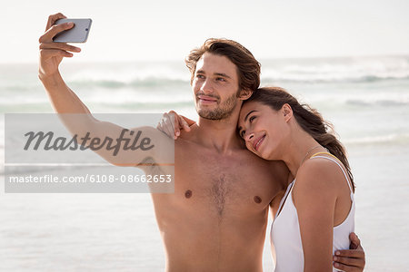 Happy young couple taking selfie with a smart phone