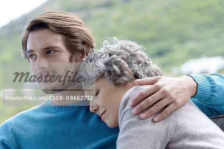 Loving son hugging his mother outdoors