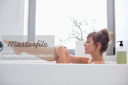 Beautiful woman relaxing in bathtub