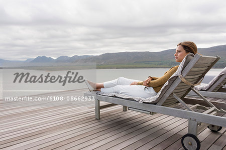 Beautiful woman relaxing at lakeshore