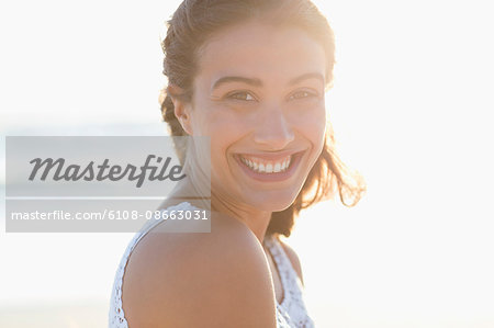 Portrait of a beautiful young woman smiling on the beach