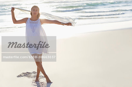 Portrait of a beautiful young woman enjoying on the beach