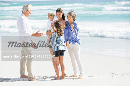 Multi-generation family standing on the beach