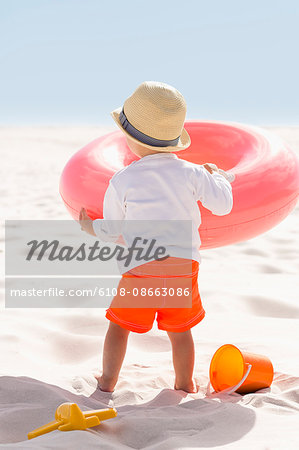 Rear view of a baby boy playing on the beach