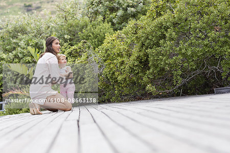 Happy mother and son on deck in garden