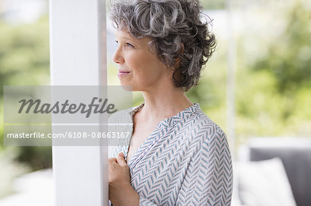 Close-up of a woman leaning against a column and thinking