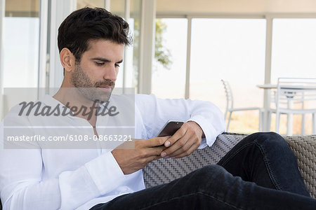 Man using a mobile phone at home