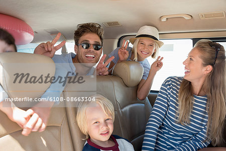 Happy young family in car for vacation