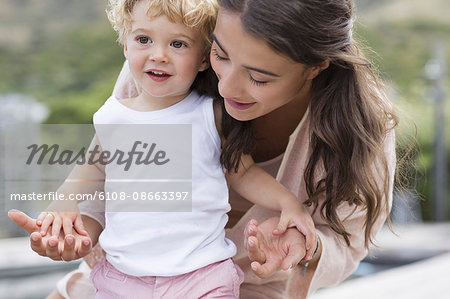 Close-up of happy mother playing with son