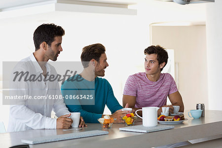 Close-up of three friends drinking coffee