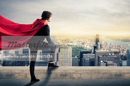 Businessman with a superhero cape view from above the city