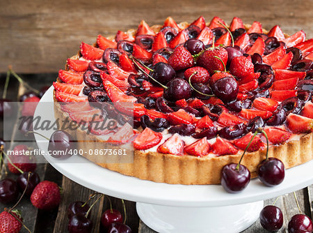 Summer tart with custard cream, fresh cherry and strawberry