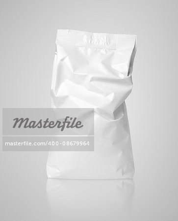 White crumpled blank paper bag package with creases on gray with clipping path