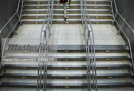 Train station stairs with metal railings at Paddington Station in London, England