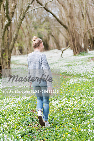 Young woman walking in park in spring