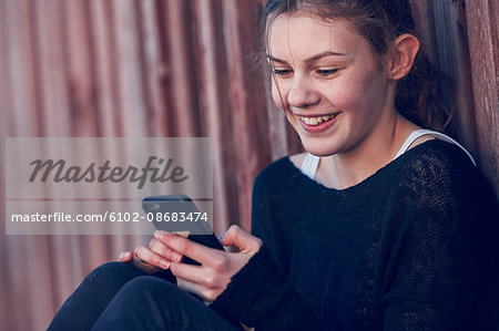 Teenage girl using cell phone