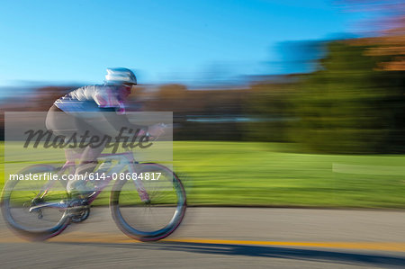 Blurred motion side view of cyclist cycling