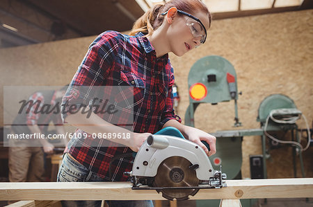 Carpenter using a machine in carpentry