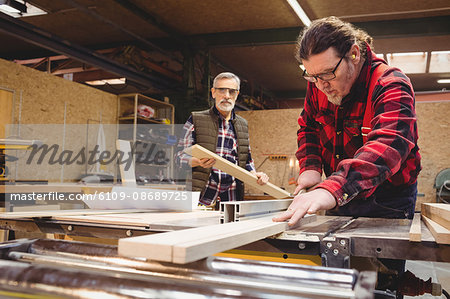 Duo of carpenter working in their workshop Duo of carpenter working in their workshop