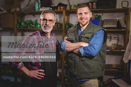 Portrait of cobbler men smiling in workshop