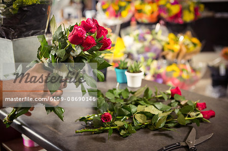 Close-Up of male florist arranging flower at his flower shop