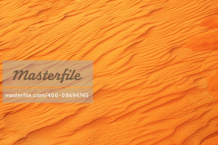 Texture of sand dune of orange color in desert, UAE