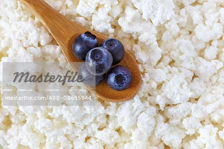 cottage cheese and the wooden spoon with blueberries