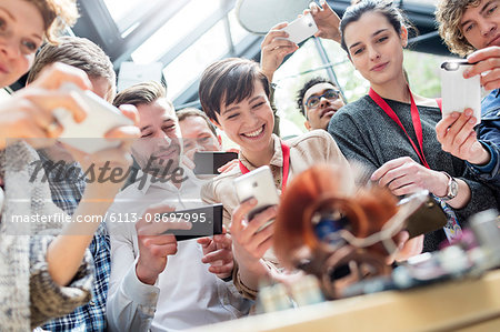 Group with camera phones at technology conference