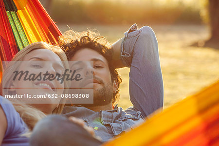 Couple relaxing together in hammock, portrait