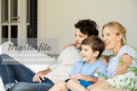 Family with one child relaxing together outdoors