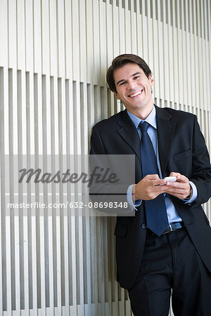 Businessman relaxing with smartphone