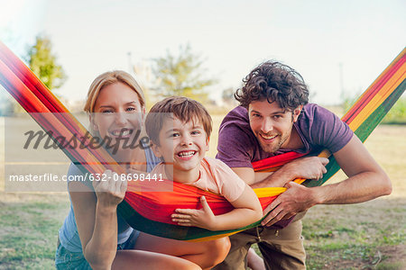 Family relaxing together outdoors, portrait