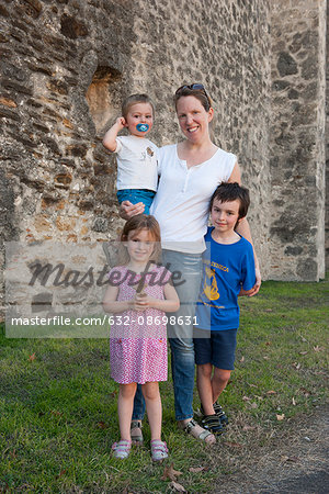 Mother and children together outdoors, portrait