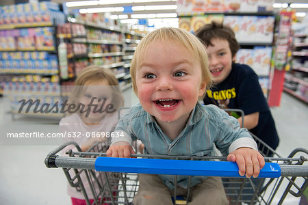 Children having fun in shopping cart