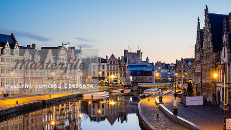 Belgium, Flanders, Ghent (Gent). The Leie River and buildings along Graslei quay at dawn.