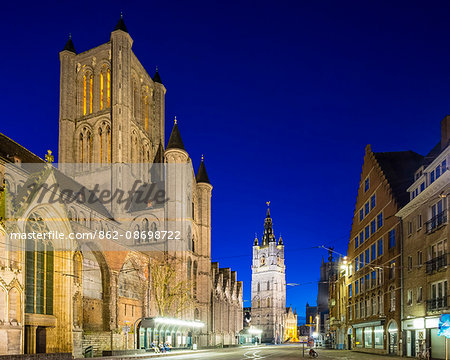 Belgium, Flanders, Ghent (Gent). Sint-Niklaaskerk (Saint Nicholas' Church) and Het Belfort van Gent, 14th century belfy, at night.