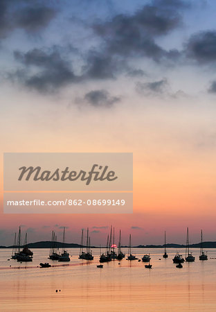 England, Isles of Scilly, St Marys. Boats moored off St Marys island at sunset.