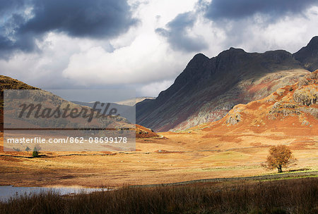 England, Cumbria, Langdale. The Langdale Pikes and Blea Tarn in dramatic light.