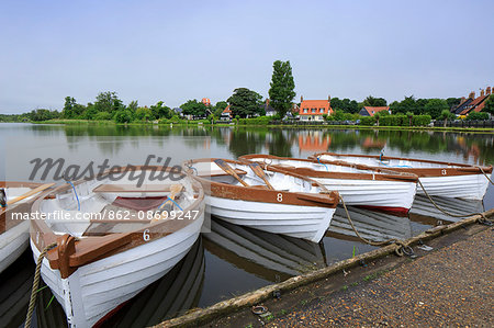 England, Suffolk, Thorpeness. Boats for hire at the boating lake in summer.