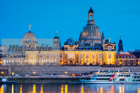 Germany, Saxony, Dresden, Altstadt (Old Town). Hochschule fur Bildende Kunste (Dresden Academy of Fine Arts) and the cupola of the Frauenkirche along the Elbe River at night.